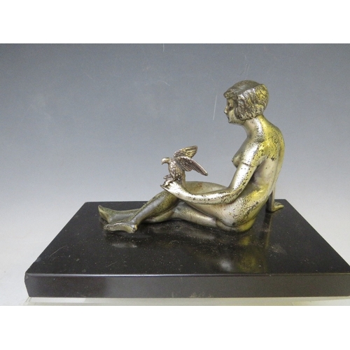 281 - A 20TH CENTURY ART DECO STUDY OF A SILVERED METAL FEMALE NUDE HOLDING A BIRD, raised on a slate base... 