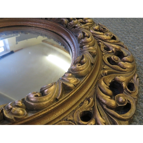 488 - A CIRCULAR CARVED WOOD AND GILT GESSO FRAMED CONVEX MIRROR, Dia. 56 cm, together with a gilt acanthu... 