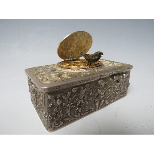 143 - A 19TH CENTURY CONTINENTAL SILVER AUTOMATON MUSICAL BIRD BOX, the case decorated with winged cherubs... 