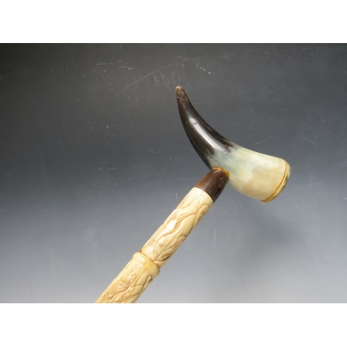 472 - A CARVED BONE WALKING STICK WITH HORN HANDLE, overall L 92 cm