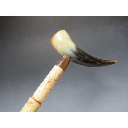 472 - A CARVED BONE WALKING STICK WITH HORN HANDLE, overall L 92 cm