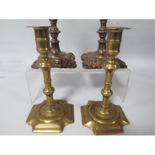 312 - A PAIR OF 18TH CENTURY GEORGE II BRASS CANDLESTICKS AND A PAIR OF GEORGE II STYLE PLATED STICKS