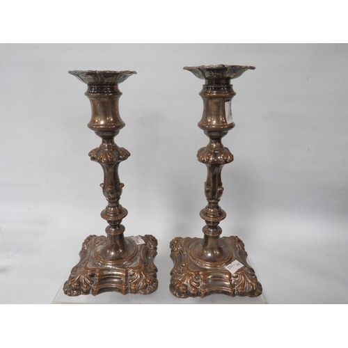 312 - A PAIR OF 18TH CENTURY GEORGE II BRASS CANDLESTICKS AND A PAIR OF GEORGE II STYLE PLATED STICKS