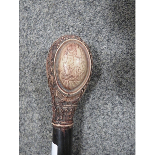 201 - A REPRODUCTION WALKING CANE WITH A CARVED HANDLE