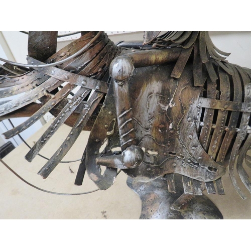 223 - AN UNUSUAL METAL KNIGHT ON HORSEBACK SCULPTURE