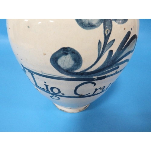 275 - AN ANTIQUE DELFT DRUG JAR, INSCRIBED 'LIG. CRUC' WITH A FLOWER ABOVE H 19 CM