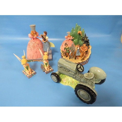 281 - TWO TINKERBELL FIGURES WITH TWO WIZARD OF OZ FIGURES AND A MODEL OF A TRACTOR (5)