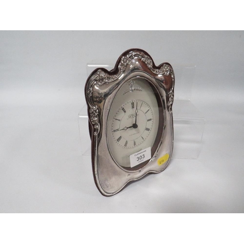 303 - A HALLMARKED SILVER TABLE CLOCK