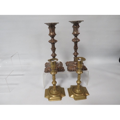 312 - A PAIR OF 18TH CENTURY GEORGE II BRASS CANDLESTICKS AND A PAIR OF GEORGE II STYLE PLATED STICKS