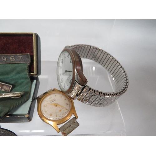 337 - A SELECTION OF VINTAGE WRIST WATCHES , SAFE DRIVING MEDALS ETC