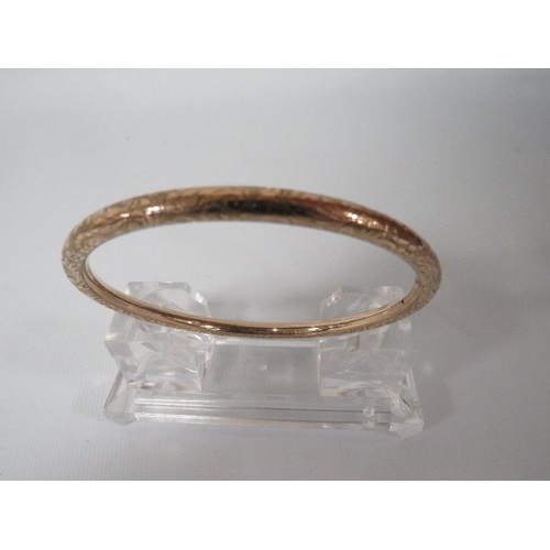 364 - AN ANTIQUE ENGRAVED BANGLE MARKED ROLLED GOLD