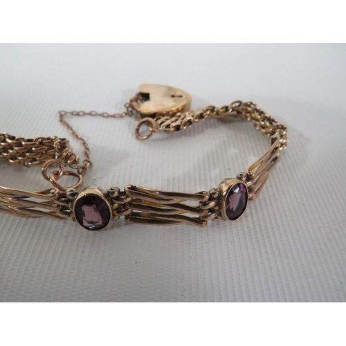 371 - AN ANTIQUE ROLLED GOLD BRACELET SET WITH PURPLE STONES