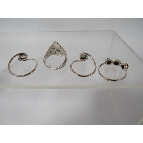 391 - THREE DECORATIVE SILVER DRESS RINGS TOGETHER WITH AN UNMARKED EXAMPLE (4)