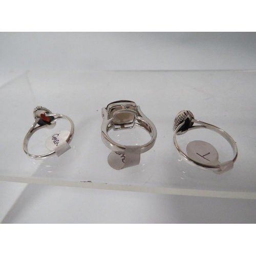 394 - THREE DECORATIVE SILVER DRESS RINGS TO INCLUDE A SMOKY QUARTZ STYLE EXAMPLE