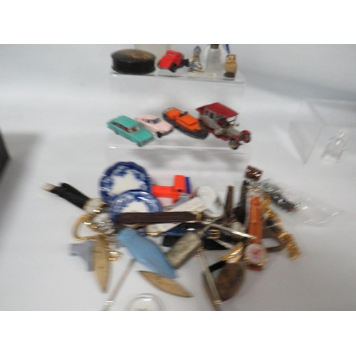 407 - A SMALL BOX OF COLLECTABLE'S TO INCLUDE WRIST WATCHES, TOY CARS ETC