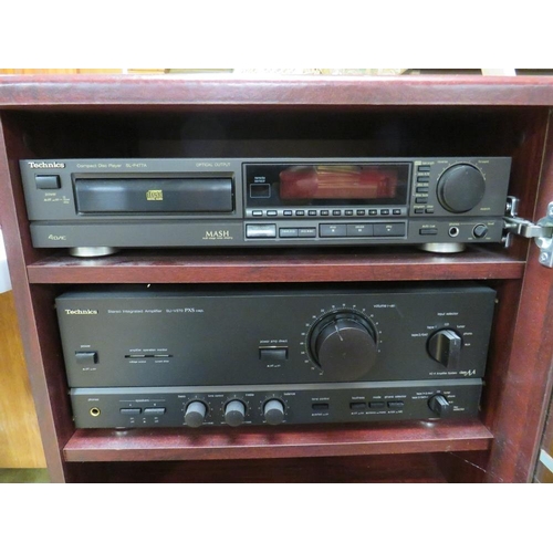 859 - A TECHNICS SU-V570 AMP AND AN SL-P477A CD PLAYER IN CABINET