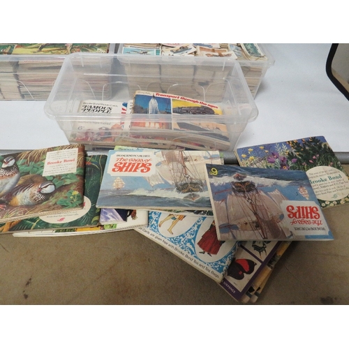 239 - THREE TRAYS OF ASSORTED CIGARETTE CARDS TO INCLUDE SHIPS, CARS ETC