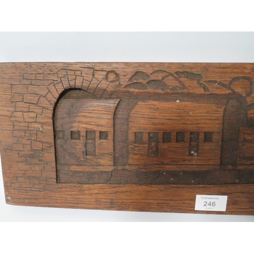 246 - A VINTAGE CARVED WOOD PANEL DEPICTING A STEAM ENGINE AND CARRIAGES EMERGING FROM A TUNNEL