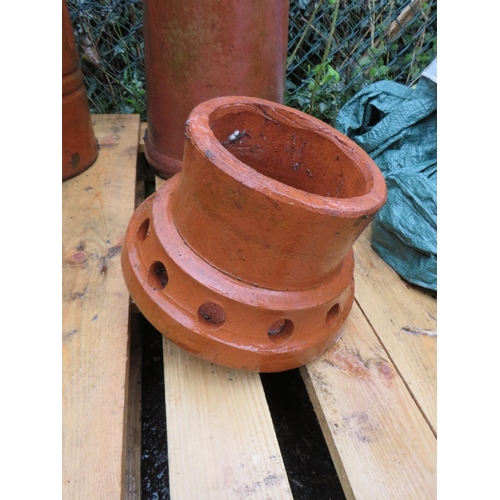 602 - TWO TERRACOTTA CHIMNEY POTS AND TWO COWLS