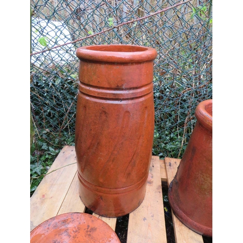 602 - TWO TERRACOTTA CHIMNEY POTS AND TWO COWLS