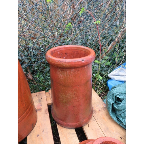 602 - TWO TERRACOTTA CHIMNEY POTS AND TWO COWLS