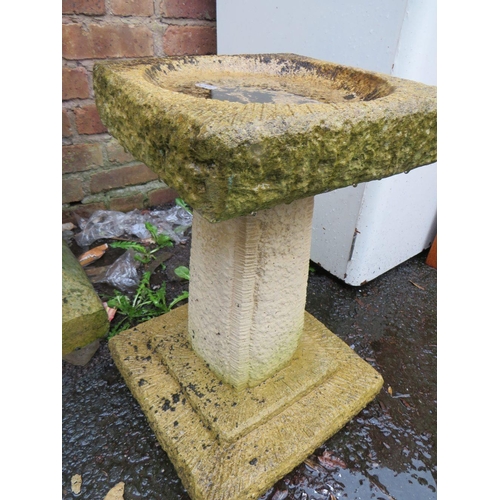 607 - A CASTELLATED CHIMNEY POT A/F TOGETHER WITH A SANDSTONE TYPE BIRD BATH AND A STADDLE STONE TYPE BASE