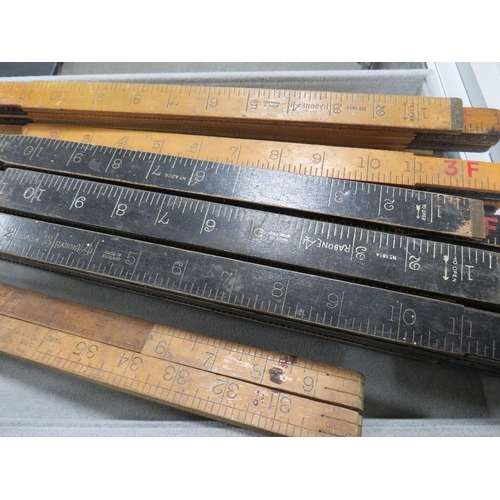 414 - A BASKET OF WOODEN MEASURE RULERS TOGETHER WITH MEASURE TAPES ETC