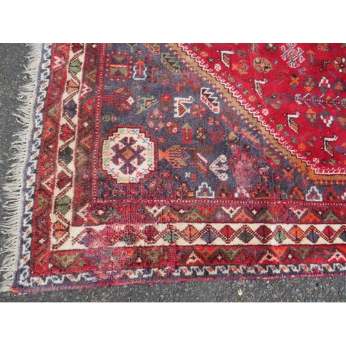 764 - A LARGE EASTERN RED/BLACK WOOLLEN RUG - APPROX 300 x 213 cm