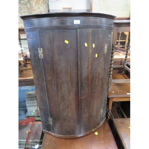 815 - AN ANTIQUE OAK BOWED HANGING CORNER CUPBOARD