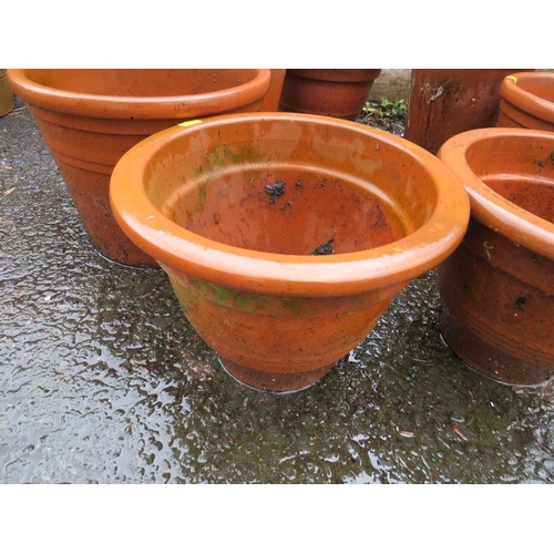 604 - A SELECTION OF SEVEN LARGE TERRACOTTA PLANTERS