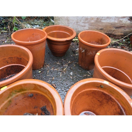 604 - A SELECTION OF SEVEN LARGE TERRACOTTA PLANTERS