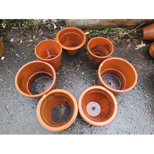 604 - A SELECTION OF SEVEN LARGE TERRACOTTA PLANTERS