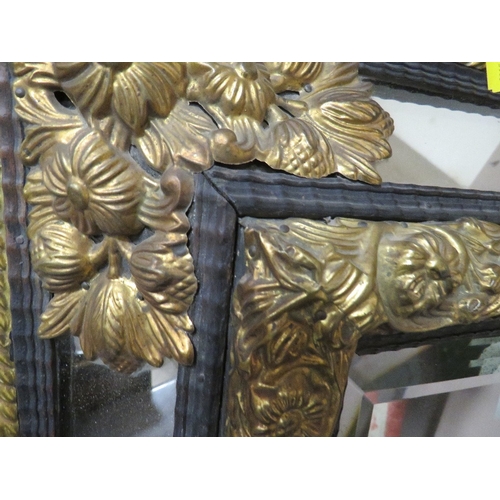 713 - A VINTAGE CUSHION FRONTED AND GILT WALL MIRROR 67 X 58 CM