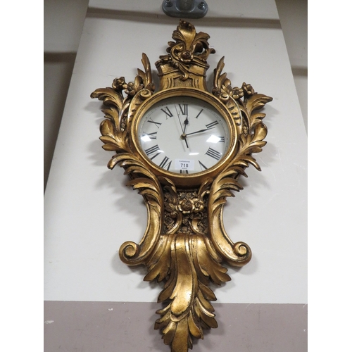 718 - A REPRODUCTION GILT WALL CLOCK AND GILT WALL MIRROR (2)