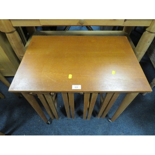 808 - A MID CENTURY TEAK NEST OF TABLES ON CASTORS