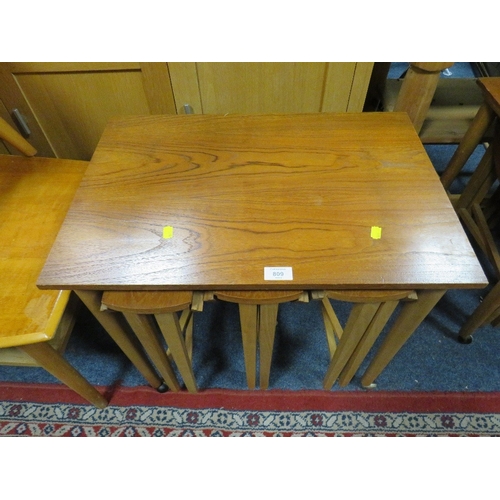 809 - A MID CENTURY TEAK NEST OF TABLES ON CASTORS