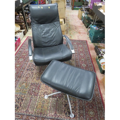 829 - A MODERN BLACK ARMCHAIR WITH STOOL