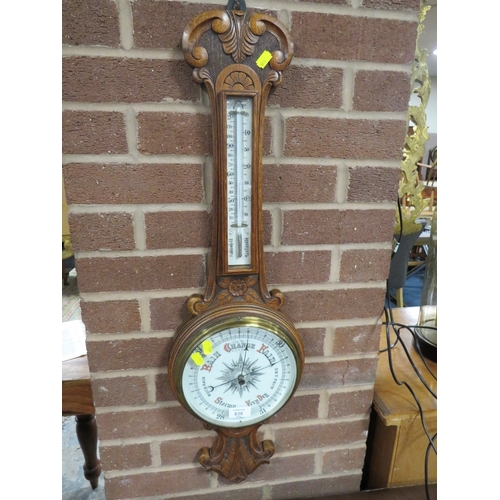 836 - A CARVED OAK ANEROID BAROMETER