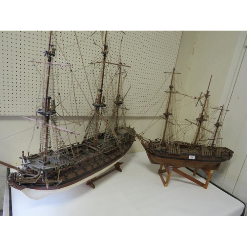 239 - A VINTAGE SCRATCH BUILT MODEL OF A GALLEON TOGETHER WITH A LARGER EXAMPLE