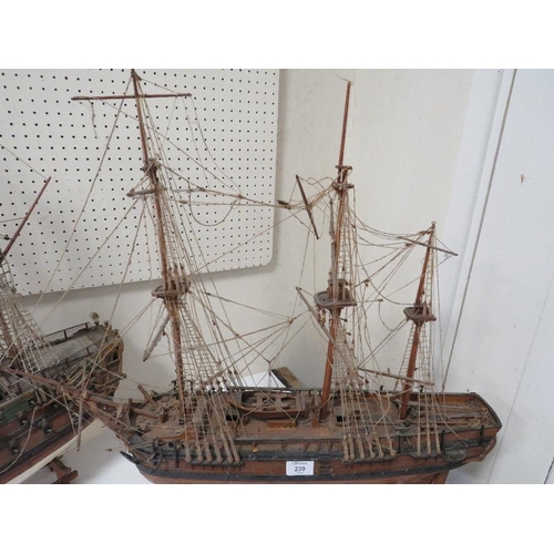 239 - A VINTAGE SCRATCH BUILT MODEL OF A GALLEON TOGETHER WITH A LARGER EXAMPLE