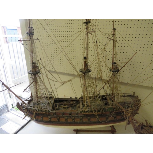 239 - A VINTAGE SCRATCH BUILT MODEL OF A GALLEON TOGETHER WITH A LARGER EXAMPLE