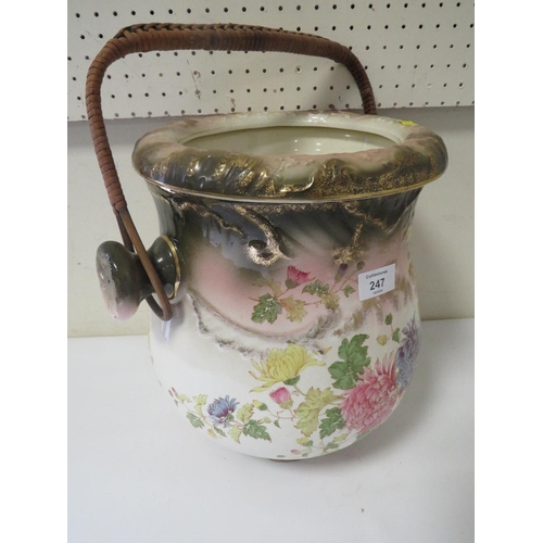 247 - A VINTAGE CERAMIC DRAINING POT WITH WICKER WORK HANDLE