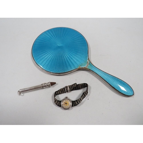 388 - THREE ITEMS OF HALLMARKED SILVER, TO INCLUDE AN ENAMEL HAND MIRROR A/F , WATCH AND A SLIDE ACTION PE... 