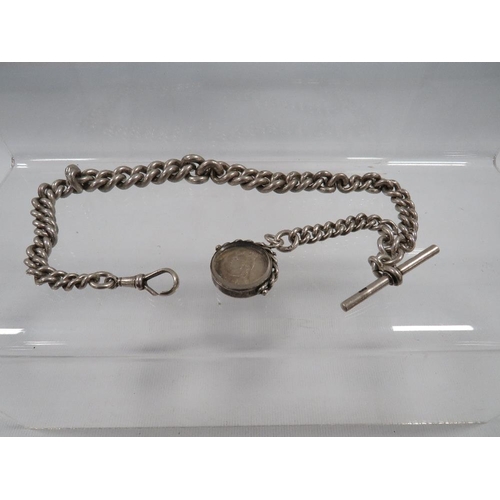 395 - A HEAVY HALLMARKED SILVER GRADUATED ALBERT WATCH CHAIN AND T -BAR  WITH MOUNTED SILVER LATE VICTORIA... 