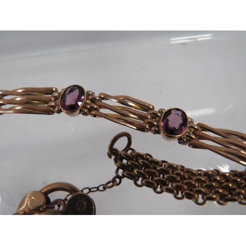 400 - A VICTORIAN ROLLED GOLD BRACELET SET WITH AMETHYST COLOURED STONES