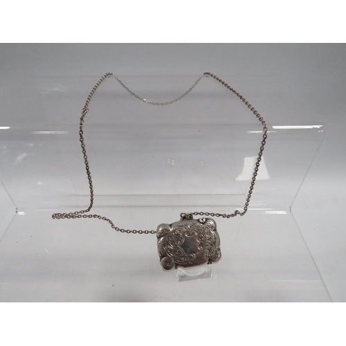 423 - AN ANTIQUE SILVER VESTA CASE ON SILVER CHAIN