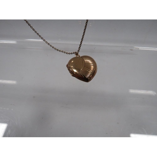 428 - AN LOCKET ON CHAIN MARKED 9CT GOLD BACK AND FRONT