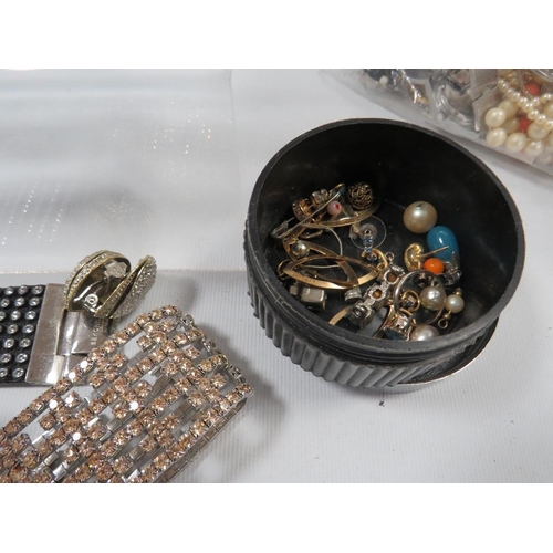 438 - A LARGE BAG OF MIXED COSTUME JEWELLERY BRACELETS, WATCHES ETC