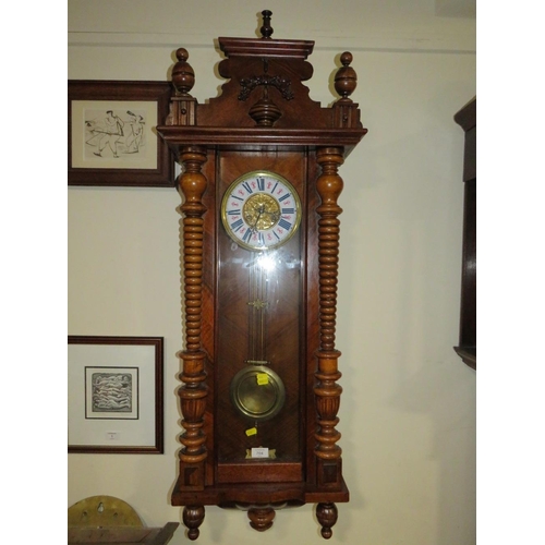 704 - AN ANTIQUE VIENNA WALLCLOCK WITH ENAMELLED DIAL