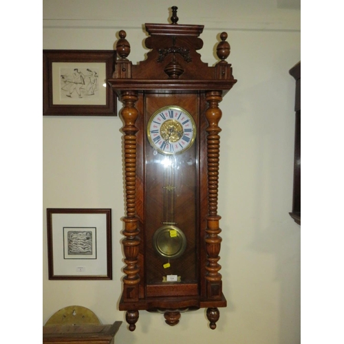 704 - AN ANTIQUE VIENNA WALLCLOCK WITH ENAMELLED DIAL